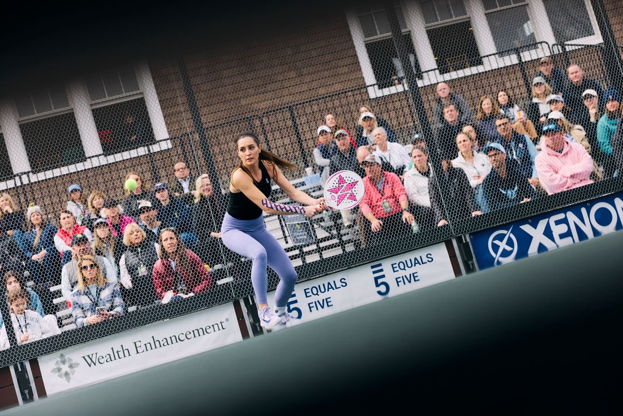 Beatriz Lopez competing in a tournament in front of a crowd, Equals 5 on the sponsor boards